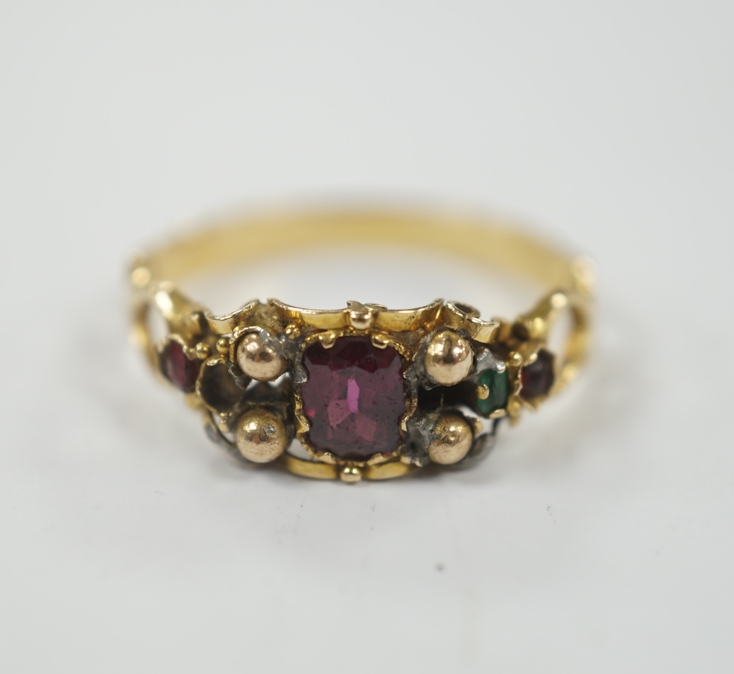 A Victorian yellow metal, garnet, ruby? and emerald set dress ring, (stones missing), size L, gross weight 1.8 grams.